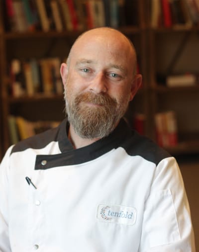 Chef in a kitchen setting at a senior living facility