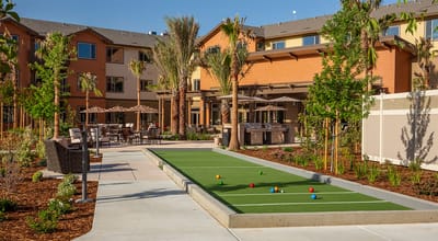 Outdoor bocce ball court surrounded by landscaping