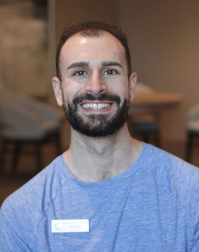 Staff member smiling in a facility interior