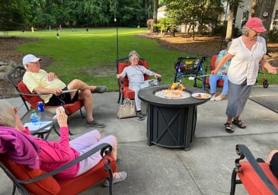 May River Landing, assisted living in Bluffton, SC — Residents enjoying a social gathering around a fire pit