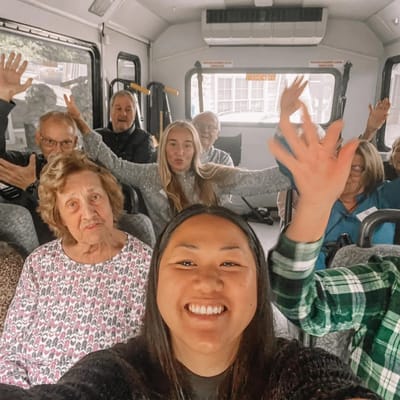 Residents and staff enjoying a ride in the facility van