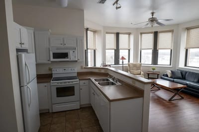 Bright, modern kitchen and living area in a resident unit