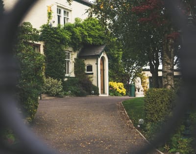 Entrance of a facility with lush greenery