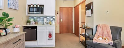 Interior view of a cozy senior living room and kitchenette