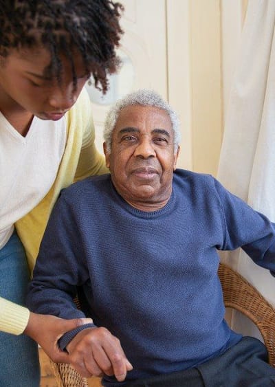 Caregiver assisting an elderly resident indoors