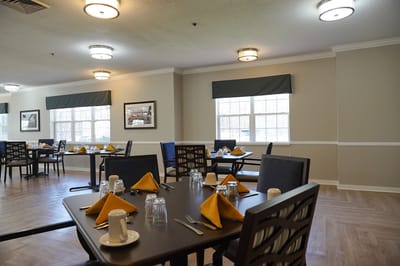 Dining area set up for meal service with tables and decor