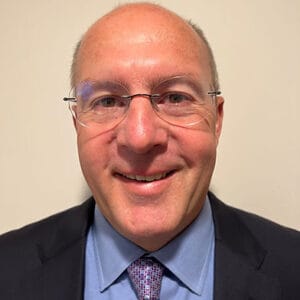 Avamere Rehabilitation of Lebanon, Nursing Home in Lebanon, OR — Smiling man in a suit with glasses