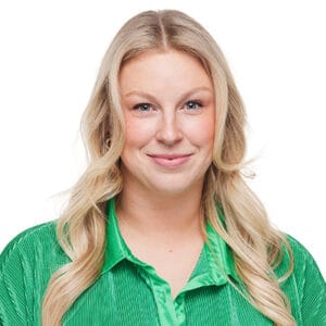 Avamere Rehabilitation of Lebanon, Nursing Home in Lebanon, OR — Smiling woman in a green shirt against a white background