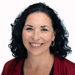 Avamere Rehabilitation of Lebanon, Nursing Home in Lebanon, OR — Smiling woman with dark curly hair and red jacket