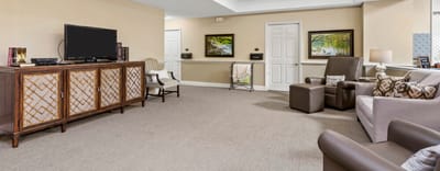 Bright common area with seating and a TV
