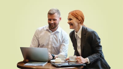 Business meeting with two people smiling over coffee