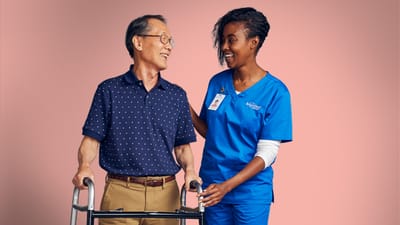 Healthcare professional smiling with an elderly man