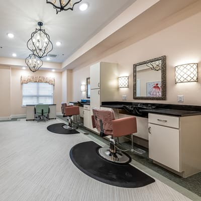 Beauty salon space with styling chairs and mirrors