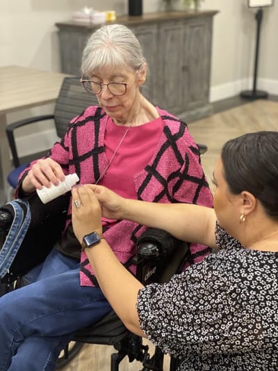 Staff member assisting a resident with a medication