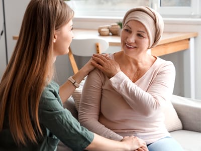 Caregiver talking with a resident in a cozy setting