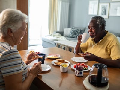 Residents enjoying breakfast at a dining table