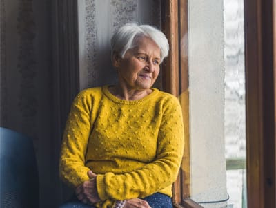 Senior woman sitting by a window