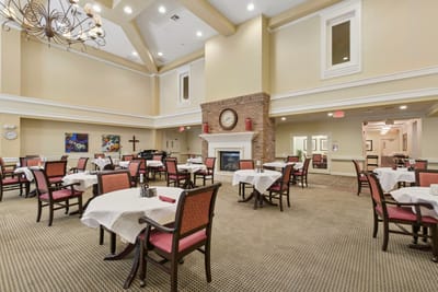 Bright dining area with tables and chairs set for meals