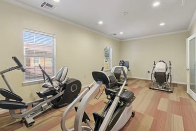 Fitness equipment in a well-lit exercise room