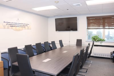 Empty meeting room with a long table and chairs