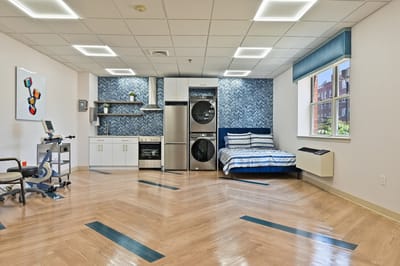 Bright interior view of a resident room with laundry