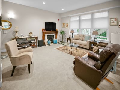 Interior view of a cozy common area with seating and television
