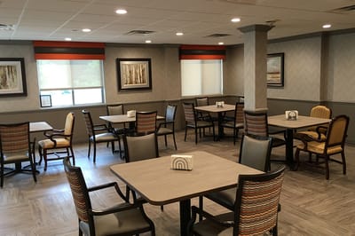 Dining area with tables and chairs in a bright interior