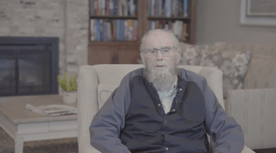 An elderly man seated in a cozy living area
