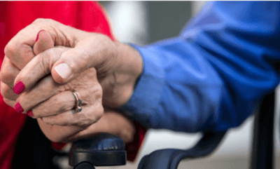 Two elderly hands clasped together