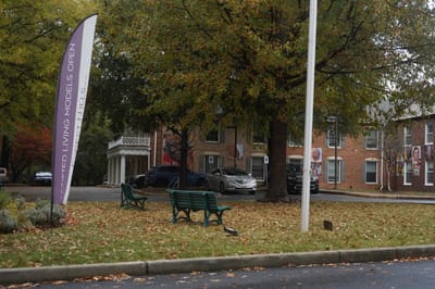 Exterior view of Forest Hills with signage and greenery