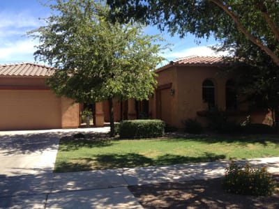Exterior view of a single-story nursing home building with landscaping