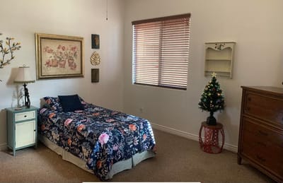 Cozy bedroom setup with floral bedding and decor