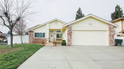 Exterior view of a single-family home with a yard