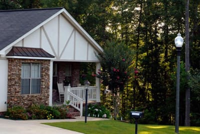 Front view of a charming assisted living home with garden