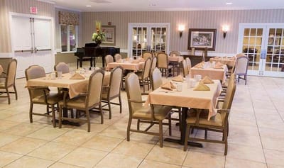 Dining area with tables and chairs set for residents