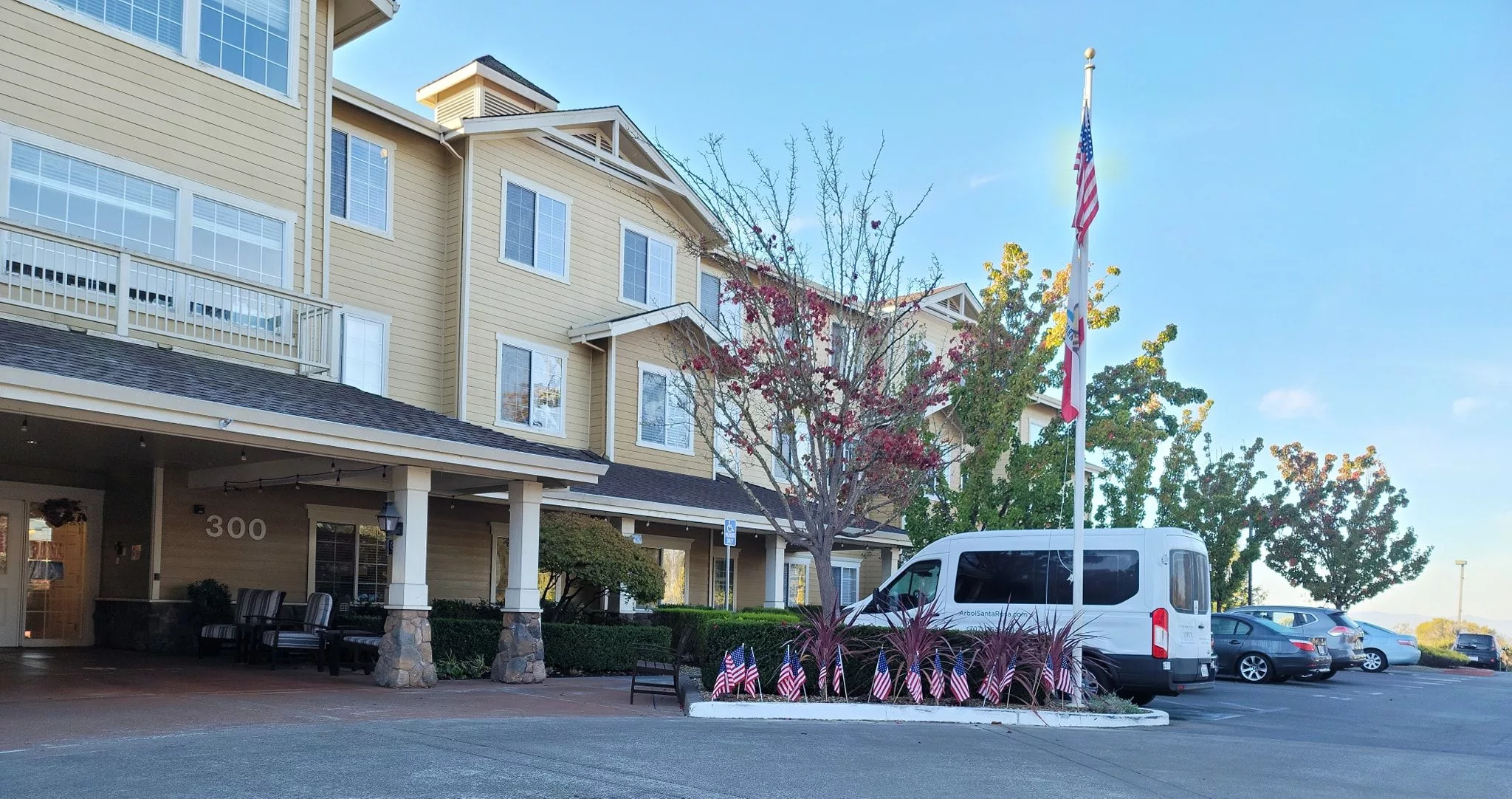 Exterior view of Arbol Residences with landscaping and van