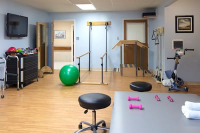 Rehabilitation exercise area with equipment and therapy station