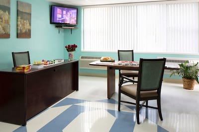 Interior view of a common room with chairs and TV