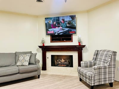 Cozy common area with a television and fireplace
