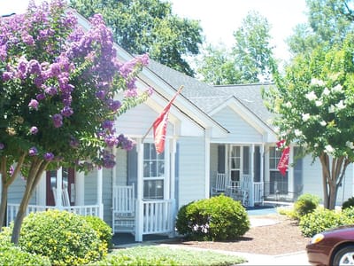 Exterior view of Bayberry Retirement Inn with flowered landscaping