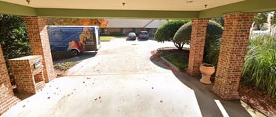 Entrance area with parked vehicles and landscaping
