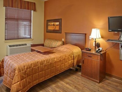 Cozy resident room with bed and furniture