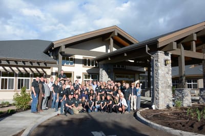 Group photo of staff in front of the facility