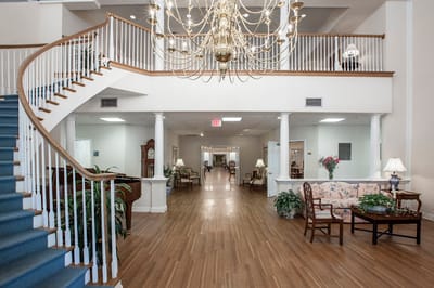 Bright common area with staircase and chandelier