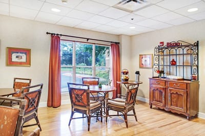 Bright and inviting common area with dining tables
