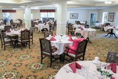 Dining room with set tables and floral carpet