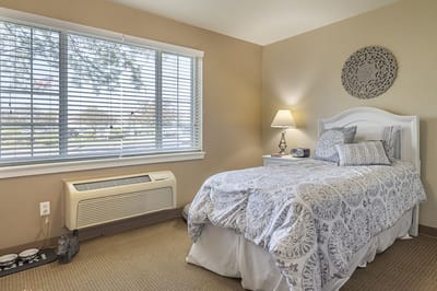 Cozy resident bedroom with natural light and decor