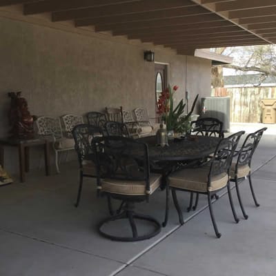 Outdoor patio area with a dining table and seating
