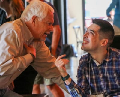 Two men engaging in a cheerful conversation