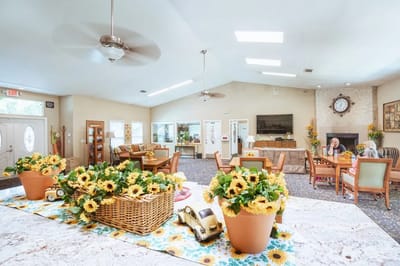 Bright common area with floral decorations and residents